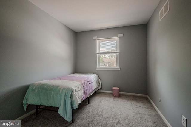 bedroom featuring visible vents, carpet flooring, and baseboards