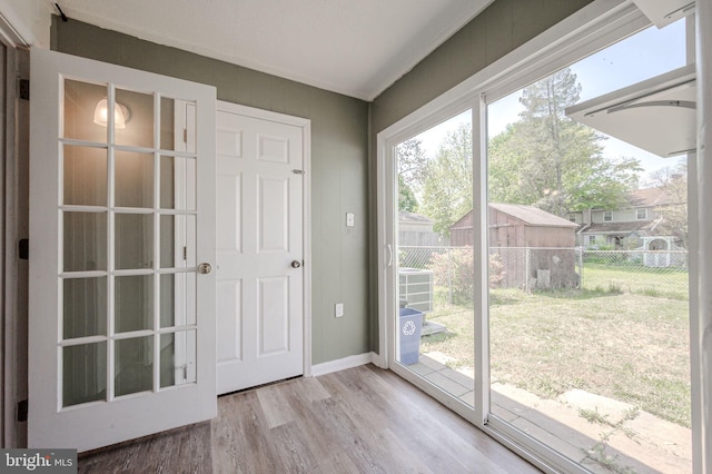 entryway with baseboards and wood finished floors