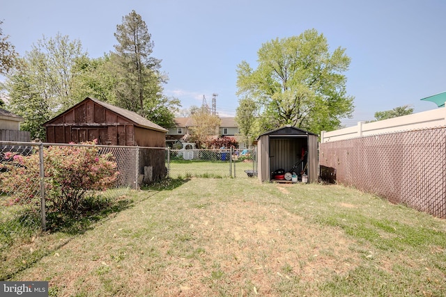 view of yard with a storage shed, an outdoor structure, and a fenced backyard