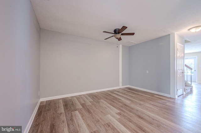 unfurnished room with baseboards, a ceiling fan, and light wood finished floors