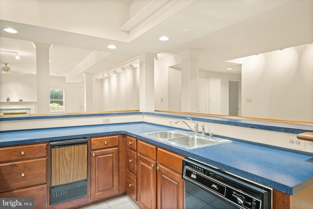 kitchen with dishwasher, brown cabinetry, light tile patterned flooring, a sink, and ornate columns
