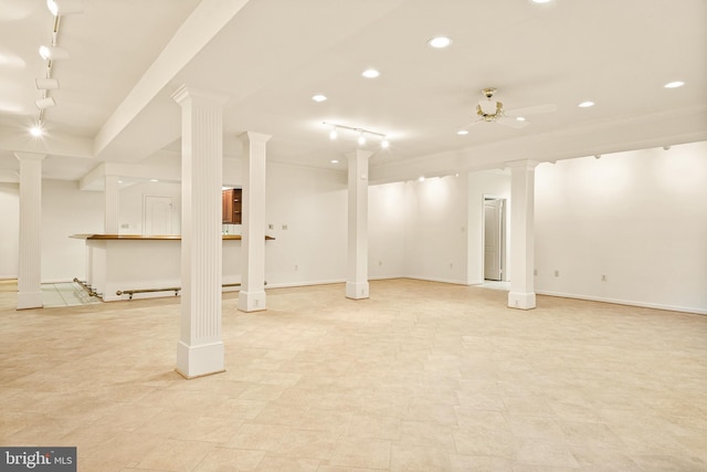 below grade area featuring track lighting, baseboards, a ceiling fan, and recessed lighting