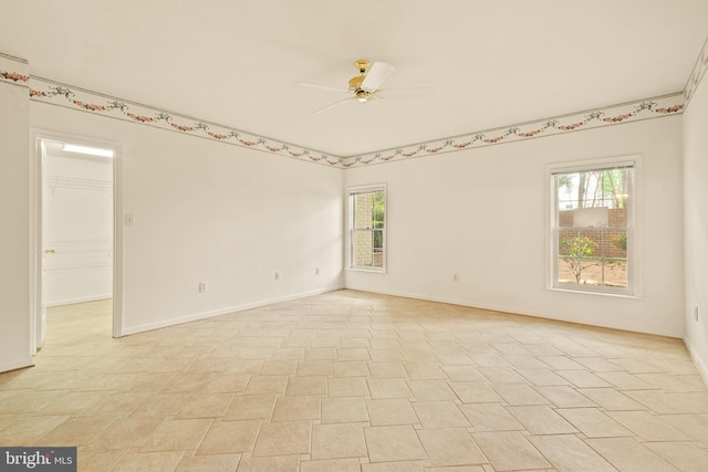 empty room featuring baseboards and a ceiling fan