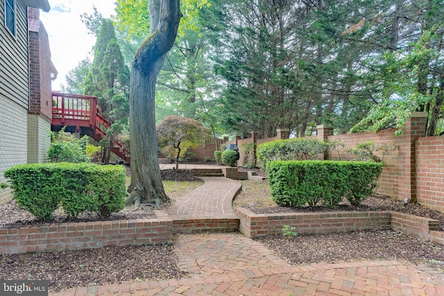 view of yard with a wooden deck and fence