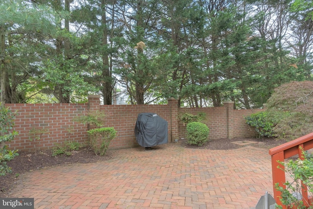 view of patio / terrace featuring grilling area and fence