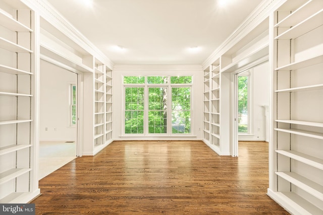 interior space with crown molding and wood finished floors