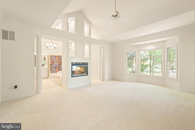 unfurnished living room featuring light colored carpet, ceiling fan with notable chandelier, baseboards, a tile fireplace, and visible vents