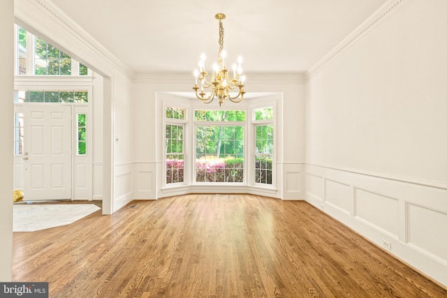 interior space featuring a wealth of natural light, a decorative wall, and an inviting chandelier