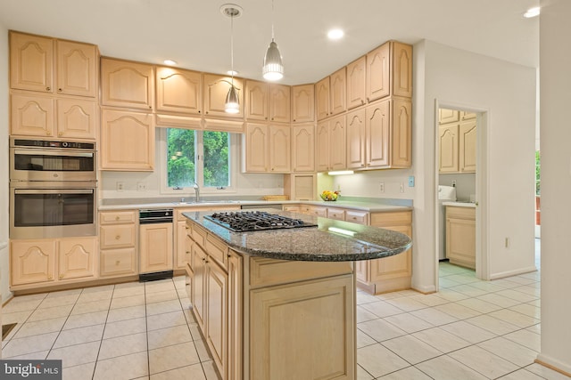 kitchen with light tile patterned floors, gas stovetop, light brown cabinets, and a sink