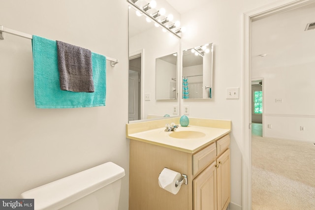 full bath with toilet, visible vents, and vanity