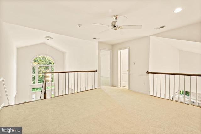 interior space featuring lofted ceiling, visible vents, recessed lighting, carpet floors, and a ceiling fan