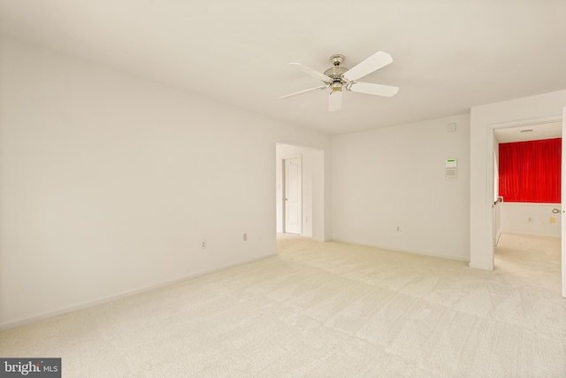 unfurnished room featuring light carpet and ceiling fan