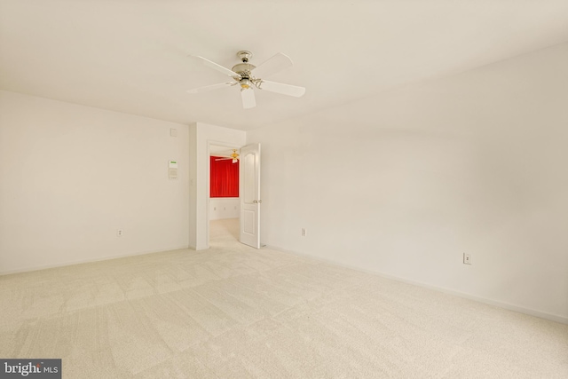 spare room featuring a ceiling fan and light colored carpet