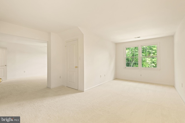 empty room featuring visible vents and carpet