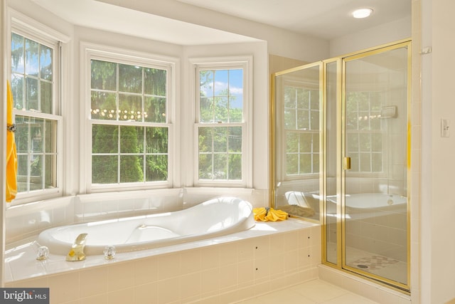 full bathroom featuring a garden tub, a shower stall, and tile patterned floors