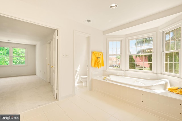 bathroom featuring recessed lighting, toilet, visible vents, tile patterned floors, and a garden tub