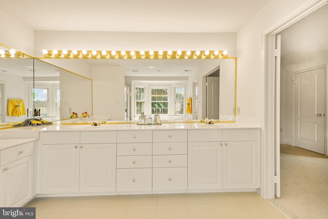 bathroom with double vanity, tile patterned flooring, and a sink