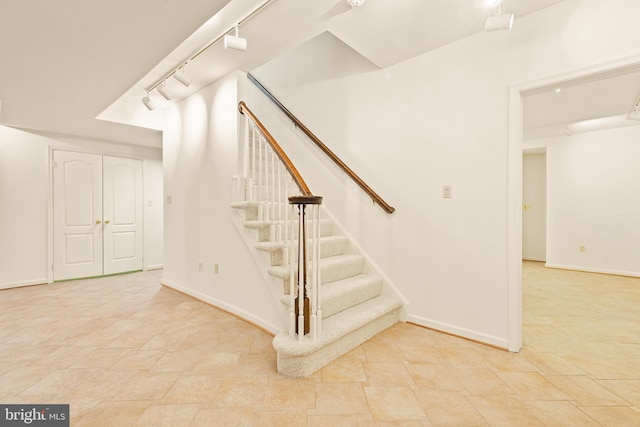 stairs with rail lighting and baseboards