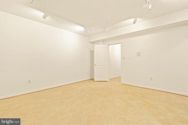empty room featuring track lighting