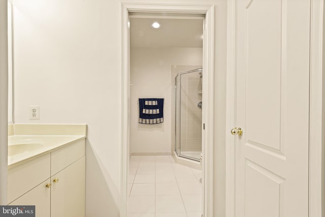 full bathroom with tile patterned floors, vanity, a stall shower, and recessed lighting