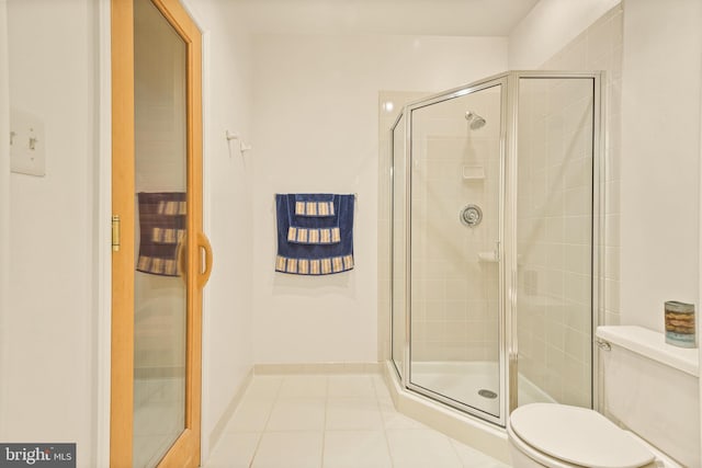 full bathroom with tile patterned floors, toilet, and a shower stall