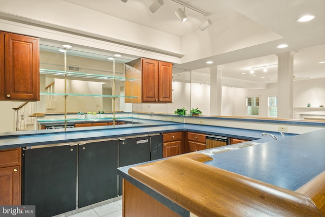 kitchen featuring track lighting, dark countertops, and brown cabinetry