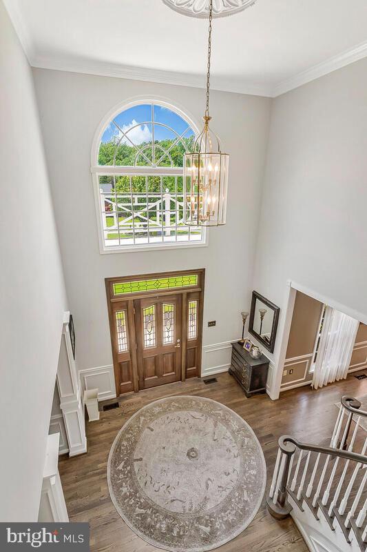 2840 Dunleigh Dr, Dunkirk, MD 20754 - foyer with a high ceiling, an inviting chandelier, ornamental molding, and wood finished floors