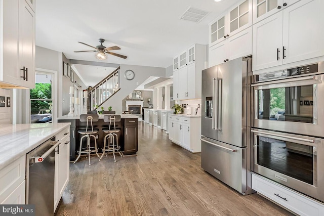 2840 Dunleigh Dr, Dunkirk, MD 20754 - kitchen with a ceiling fan, visible vents, wood finished floors, white cabinets, and stainless steel appliances