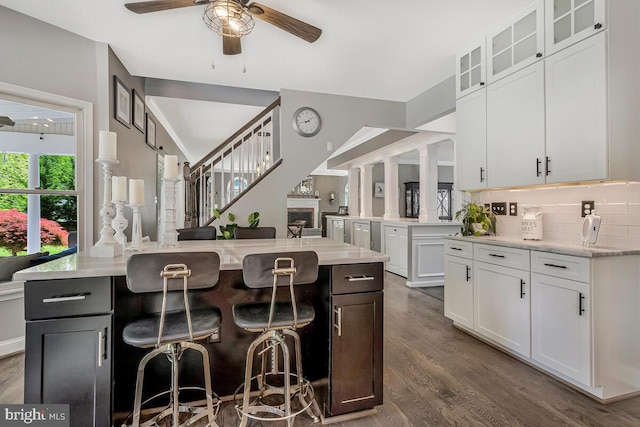 2840 Dunleigh Dr, Dunkirk, MD 20754 - kitchen featuring a breakfast bar area, a ceiling fan, white cabinets, and dark wood finished floors