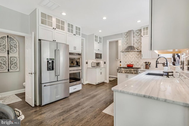 2840 Dunleigh Dr, Dunkirk, MD 20754 - kitchen featuring light stone counters, white cabinets, stainless steel appliances, wall chimney exhaust hood, and dark wood-type flooring