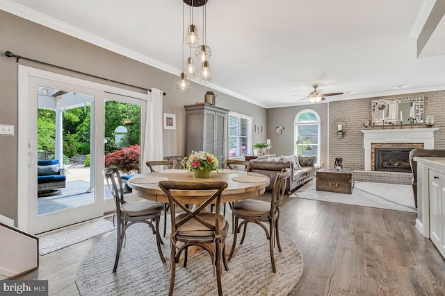 2840 Dunleigh Dr, Dunkirk, MD 20754 - dining space with crown molding, ceiling fan, wood finished floors, and a fireplace
