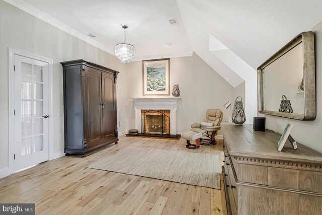 2840 Dunleigh Dr, Dunkirk, MD 20754 - living area with an inviting chandelier, visible vents, crown molding, a fireplace, and light wood-style floors