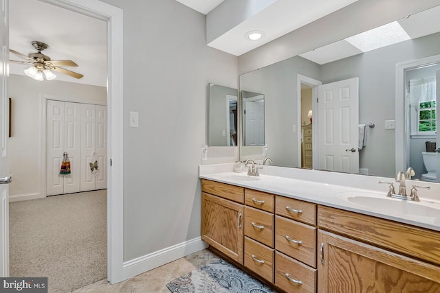 2840 Dunleigh Dr, Dunkirk, MD 20754 - full bathroom with double vanity, a sink, a ceiling fan, and toilet