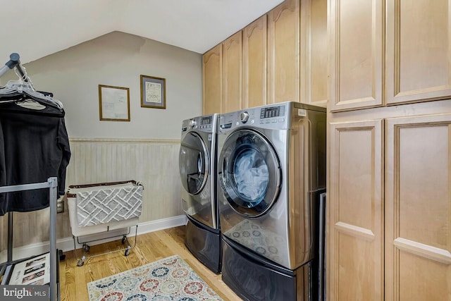 2840 Dunleigh Dr, Dunkirk, MD 20754 - clothes washing area featuring cabinet space, wainscoting, washing machine and dryer, and light wood-style flooring