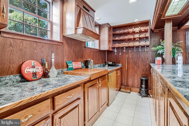 2840 Dunleigh Dr, Dunkirk, MD 20754 - kitchen featuring brown cabinetry, open shelves, wooden walls, a sink, and light tile patterned floors