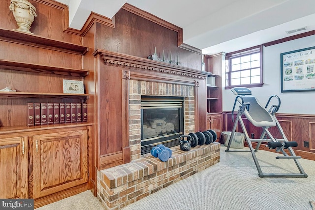 2840 Dunleigh Dr, Dunkirk, MD 20754 - exercise room with visible vents, crown molding, a brick fireplace, a wainscoted wall, and carpet
