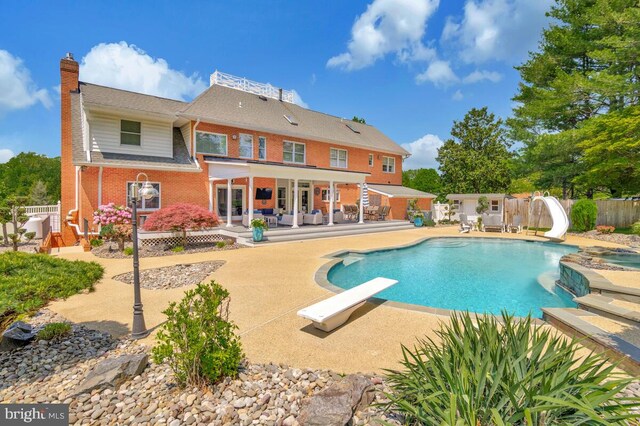 2840 Dunleigh Dr, Dunkirk, MD 20754 - view of pool with fence, a diving board, a water slide, a fenced in pool, and a patio area