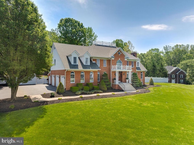 2840 Dunleigh Dr, Dunkirk, MD 20754 - colonial inspired home featuring a front yard, brick siding, fence, concrete driveway, and an attached garage