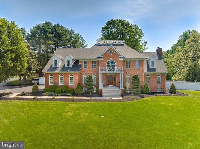 2840 Dunleigh Dr, Dunkirk, MD 20754 - georgian-style home featuring fence, a chimney, a front yard, and brick siding