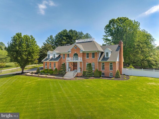 2840 Dunleigh Dr, Dunkirk, MD 20754 - view of front of property featuring brick siding, fence, a chimney, and a front lawn