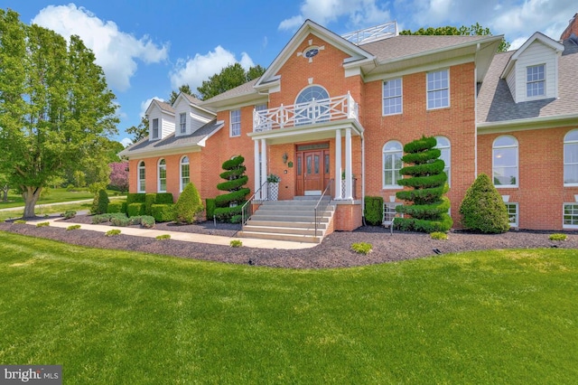 2840 Dunleigh Dr, Dunkirk, MD 20754 - georgian-style home featuring brick siding, roof with shingles, and a front lawn
