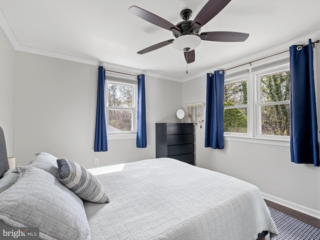 bedroom with crown molding, a ceiling fan, and baseboards