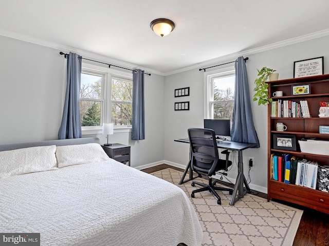 bedroom with baseboards, ornamental molding, and wood finished floors