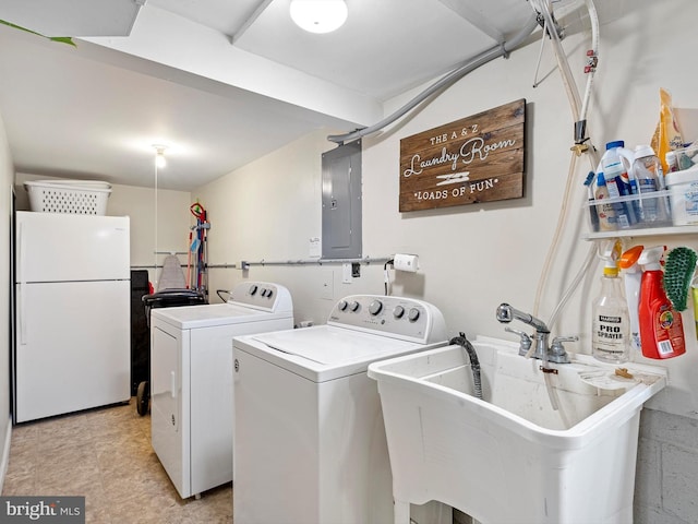 washroom with washer and clothes dryer, electric panel, laundry area, and a sink