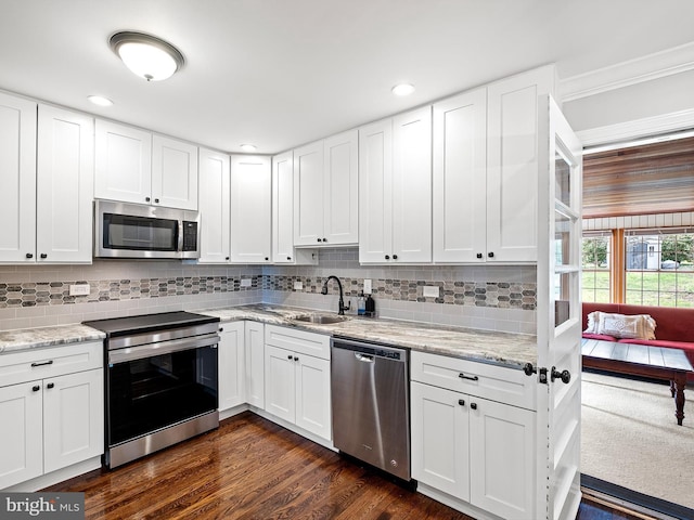 kitchen with white cabinetry, stainless steel appliances, and a sink