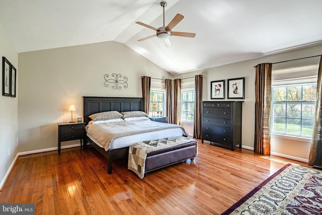 bedroom featuring baseboards, ceiling fan, vaulted ceiling, and light wood finished floors
