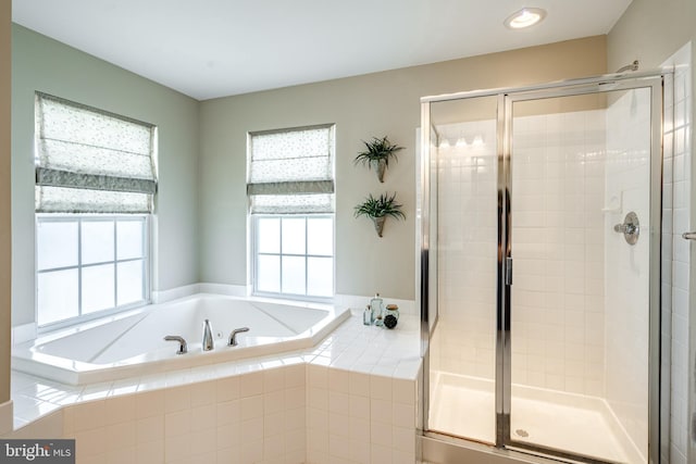 bathroom with a shower stall, recessed lighting, and a garden tub