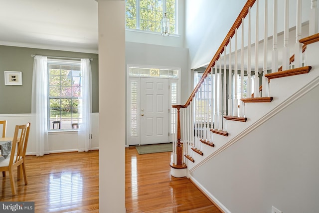 foyer entrance with stairway and wood finished floors