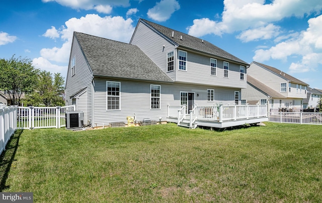 rear view of house featuring a wooden deck, a fenced backyard, a shingled roof, a lawn, and central air condition unit