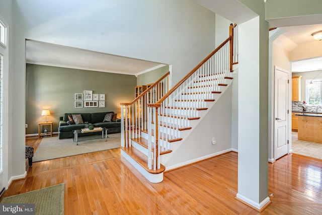 stairway with baseboards and wood finished floors